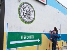 Students repainting Massapequa mural, still featuring 'Chiefs' mascot