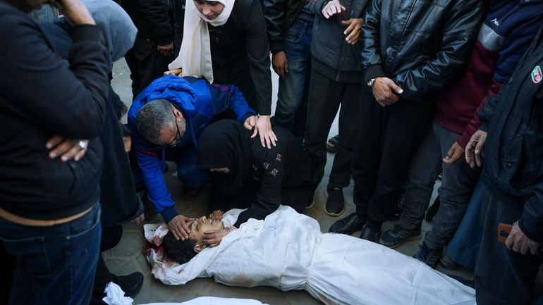 Palestinians mourn their relatives killed in the Israeli bombardments of...