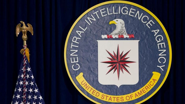 The seal of the Central Intelligence Agency stands next to...