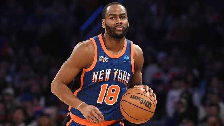 Knicks guard Alec Burks dribbles the ball upcourt against the...