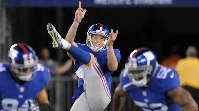 New York Giants punter Brad Wing punts the ball against...