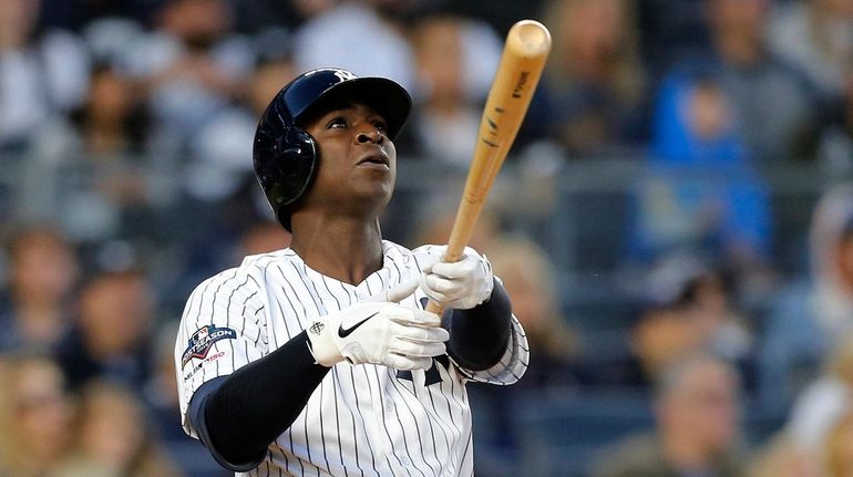 Didi Gregorius #18 of the Yankees follows through on a...