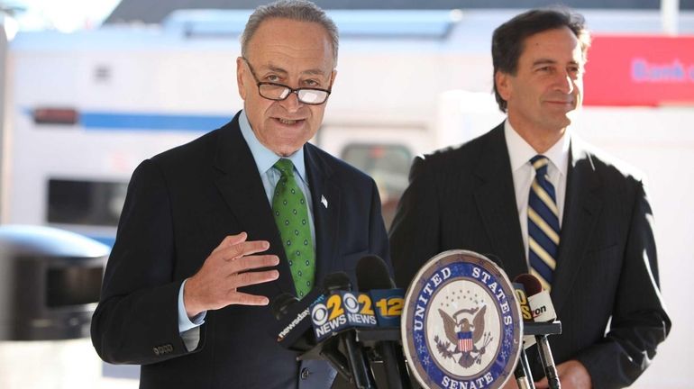 Sen. Chuck Schumer, left, speaks about improvements to the problem-plagued...