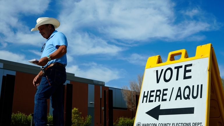 A voter walks to a voting precinct prior to casting...