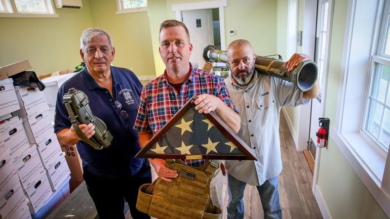 VFW Post 6249 Commander Joe Cognitore, historian Rich Acritelli and trustee Frank Lombardi hold...