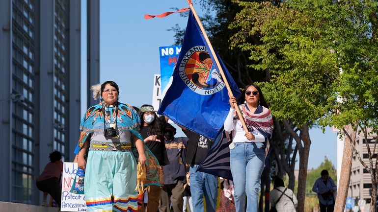 Zoe Perry, left, and Loveena Watahomiegie, right, as they join...