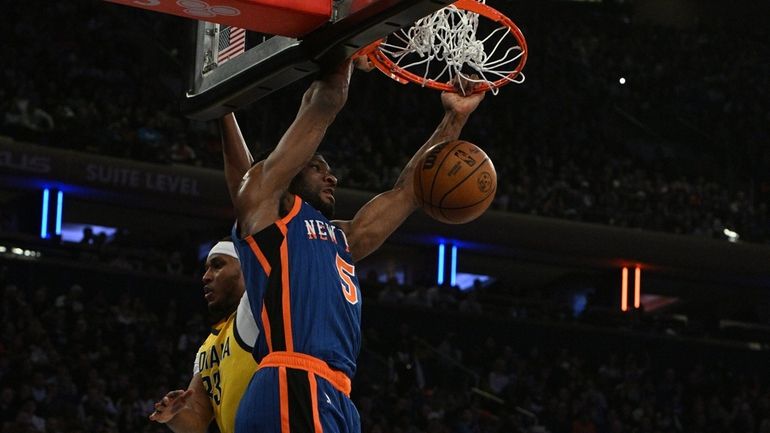 Knicks forward Precious Achiuwa dunks past Indiana Pacers center Myles...