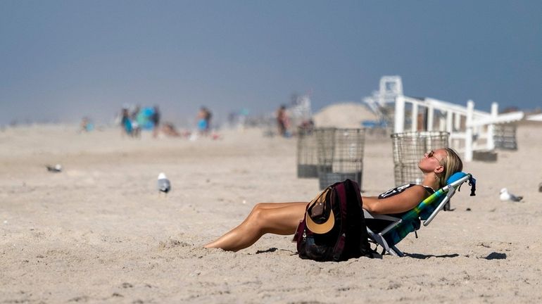 Emma Haverilla of Northport tries to stay cool along the shore at Jones...