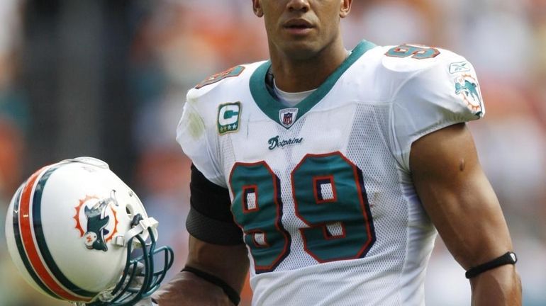 Miami Dolphins linebacker Jason Taylor (99) walks onto the field...