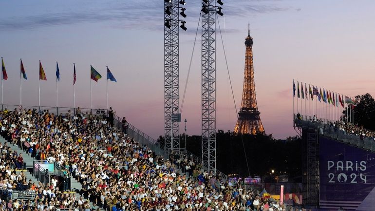 Spectators attend the Opening Ceremony for the 2024 Paralympics, Wednesday,...