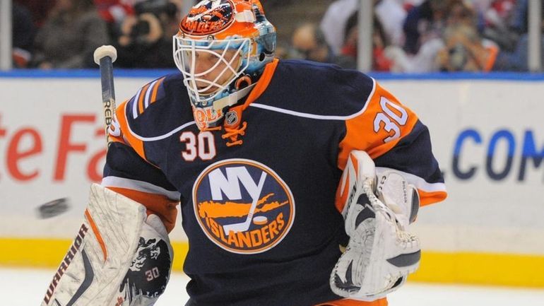 Islanders goalie Dwayne Roloson (30) makes a save during the...