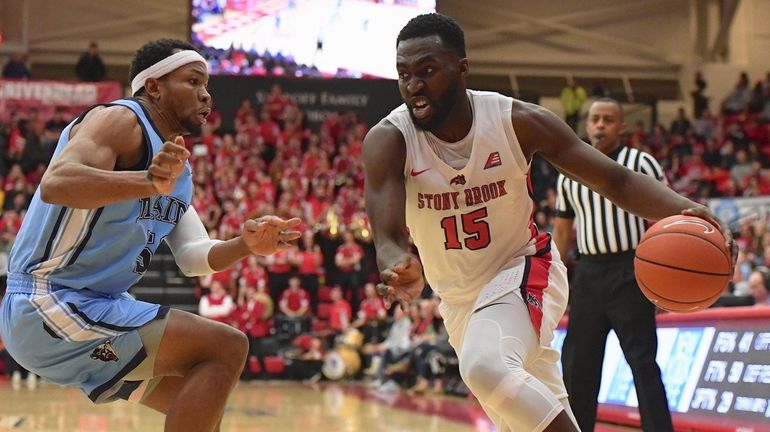 Stony Brook guard Akwasi Yeboah drives the ball defended by...