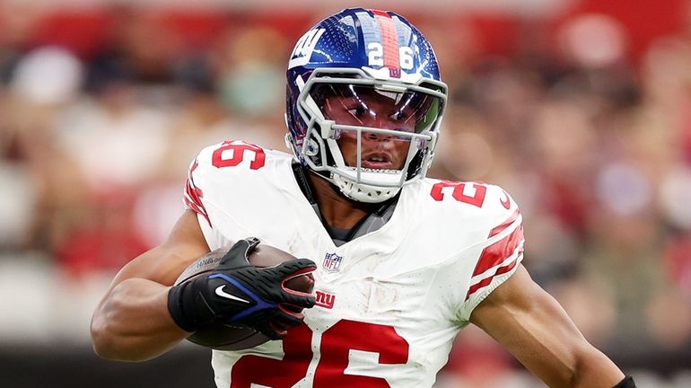 Saquon Barkley of the Giants runs the ball during the first...