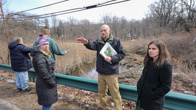 Head of the Harbor Mayor Douglas Dahlgard points to a stand...