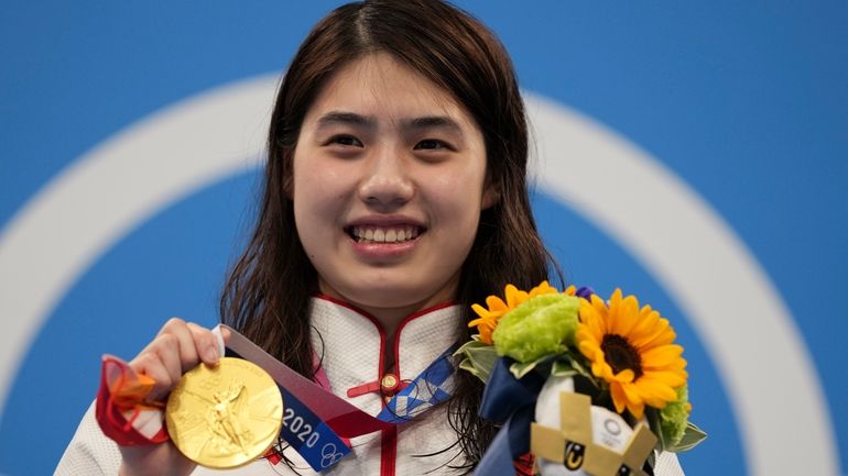 Zhang Yufei of China poses with her gold medal after...
