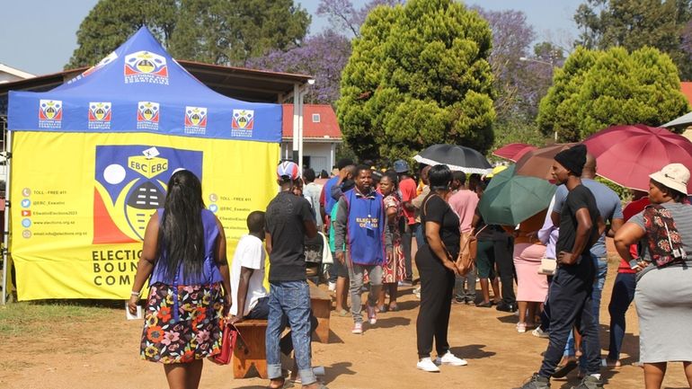 Voters queue to cast their votes in Manzini, Eswatini, Friday,...