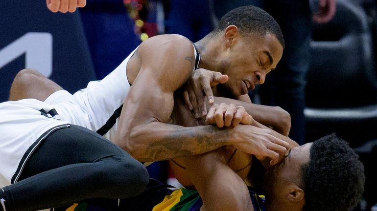 Nets center Nic Claxton, top, battles Pelicans forward Herbert Jones, bottom,...