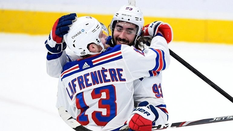 Rangers center Mika Zibanejad and left wing Alexis Lafrenière celebrate...