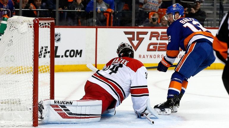 Petr Mrazek #34 of the Carolina Hurricanes stops a breakaway...