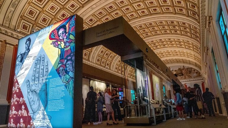 People visit the exhibit, "Collecting Memories: Treasures from the Library...