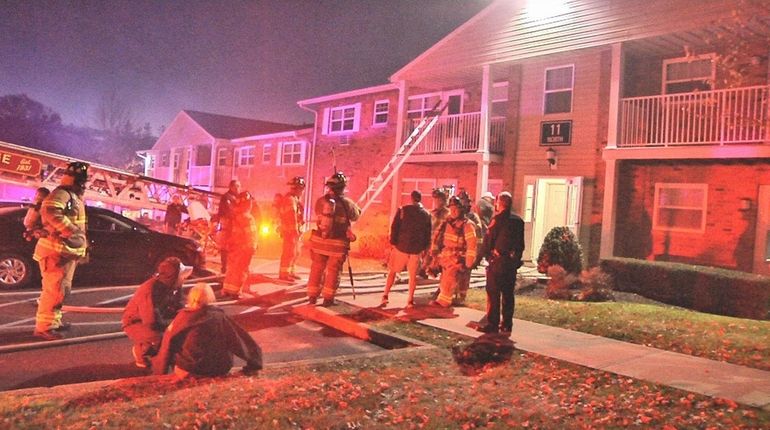 Firefighters respond to an apartment complex fire in Hauppauge Saturday...