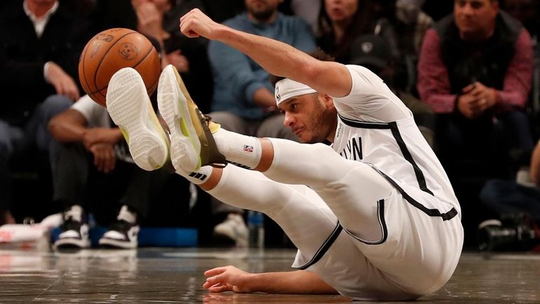 Seth Curry of the Nets slips on the court during the...