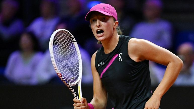 Poland's Iga Swiatek celebrates defeating Belgium's Elise Mertens after the...