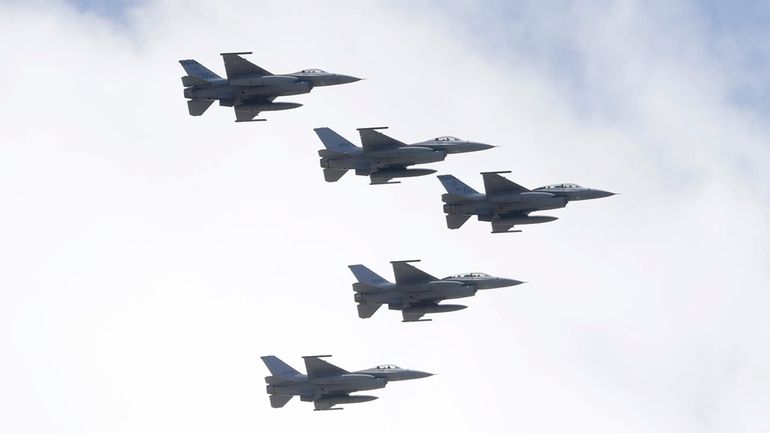 Taiwan's F-16 fighter jets fly in close formation over President...