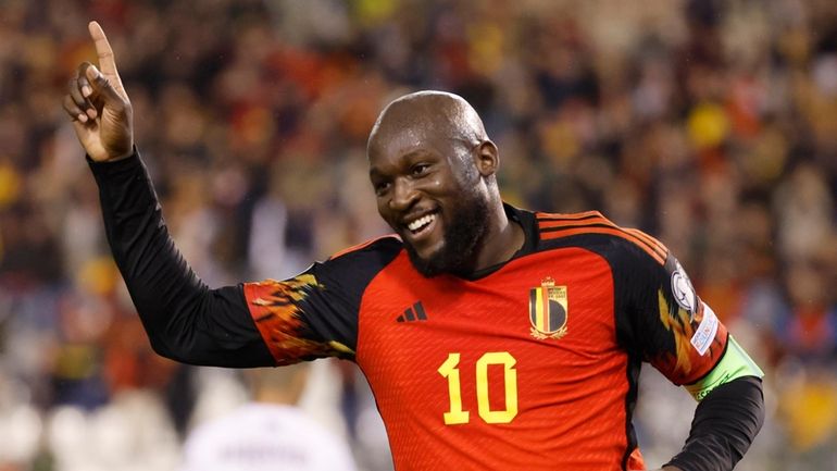 Belgium's Romelu Lukaku, right, celebrates after scoring his sides third...