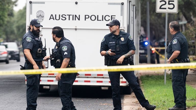 The Austin Police Department investigates the crime scene after an...