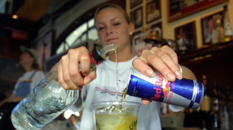 A bartender mixes Red Bull with vodka in Key West,...