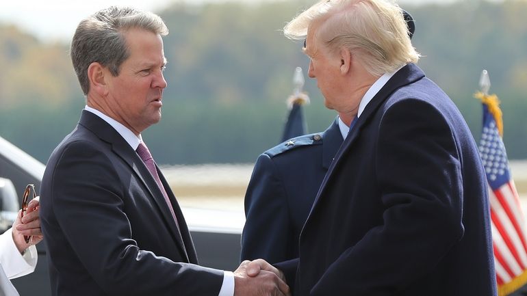 Georgia Gov. Brian Kemp, left, greets President Donald Trump as...