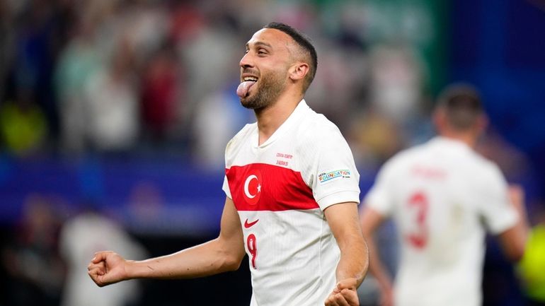 Turkey's Cenk Tosun celebrates after scoring his side's second goal...