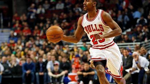 Chicago Bulls guard Marquis Teague brings the ball up court...