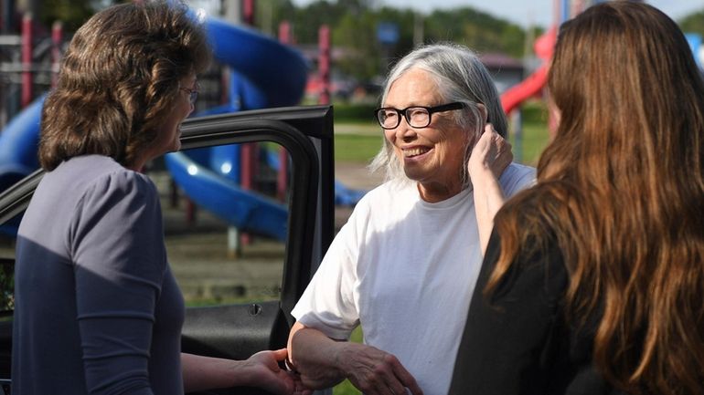 Sandra Hemme, center, meets with family and supporters after she...