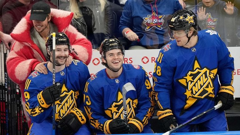 Performer Justin Bieber, second from top left, hypes up NHL...