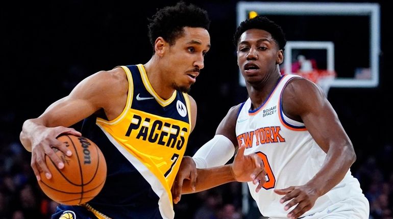 The Pacers' Malcolm Brogdon drives past the Knicks' RJ Barrett during...