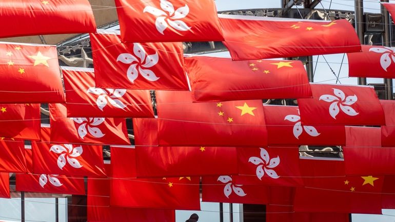 China and Hong Kong flags are hung as the city...