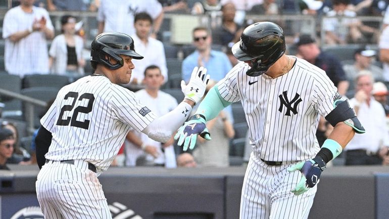 New York Yankees’ Aaron Judge is greeted by Juan Soto...