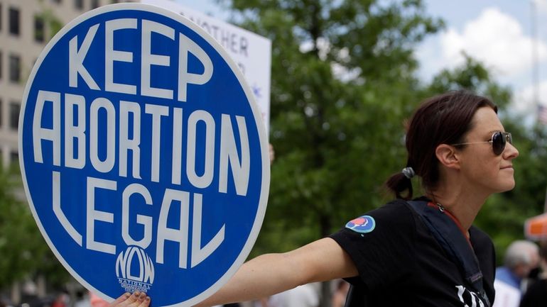 An. Abortion rights demonstrator holds a sign during a rally...