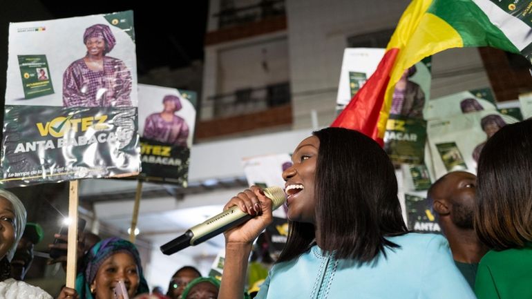 Presidential candidate Anta Babacar Ngom greets supporters during her electoral...