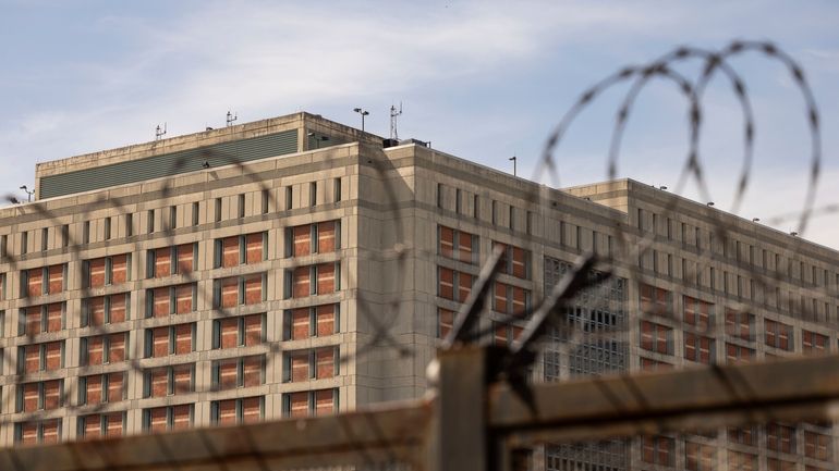 The Metropolitan Detention Center is seen through barb wire in...