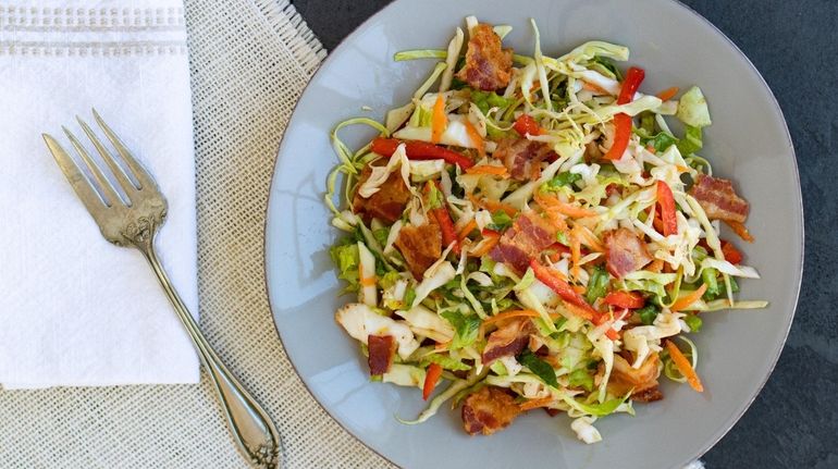 A salad of shredded cabbage and romaine, red bell pepper,...