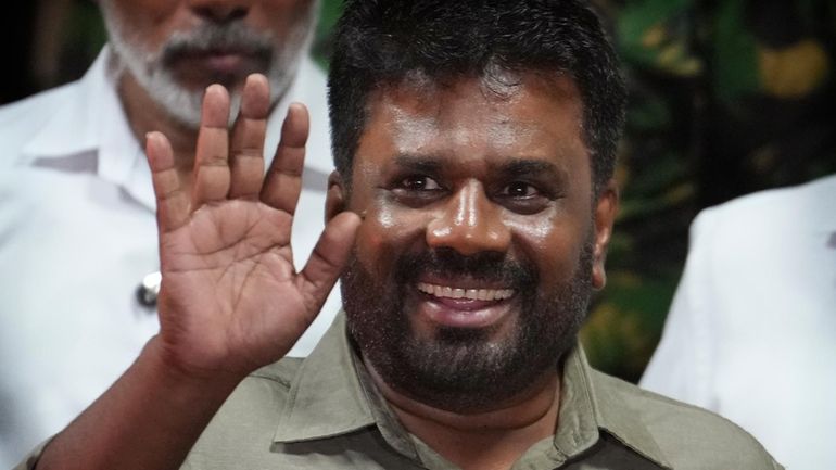 FILE -Marxist lawmaker Anura Kumara Dissanayake waves as he leaves...