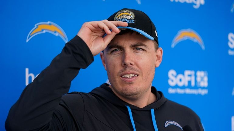 Los Angeles Chargers offensive coordinator Kellen Moore talks to reporters...