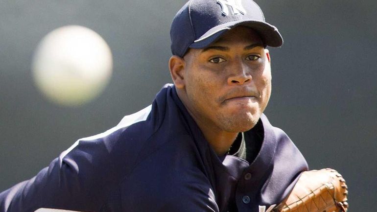 Yankees starting pitcher Ivan Nova warms up before facing the...