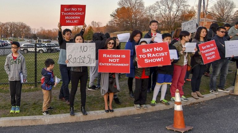 Protesters gather outside Huntington High School on Saturday in opposition...