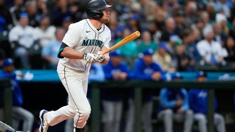 Seattle Mariners' Luke Raley follows through on a two-run home...