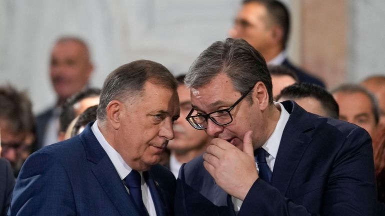 Bosnian Serb political leader Milorad Dodik, left, speaks with Serbian...