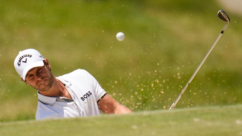 Thomas Detry, of Belgium, hits from the bunker on the...